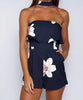 Combinaison à imprimé floral bleu marine élégante de chez [Store Name], parfaite pour un look chic et moderne.